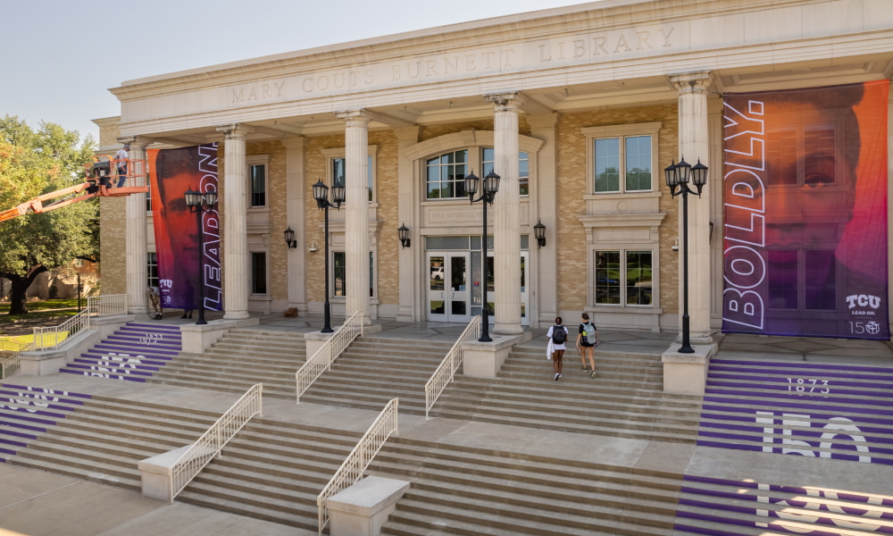 facilities employees installing outdoor banners