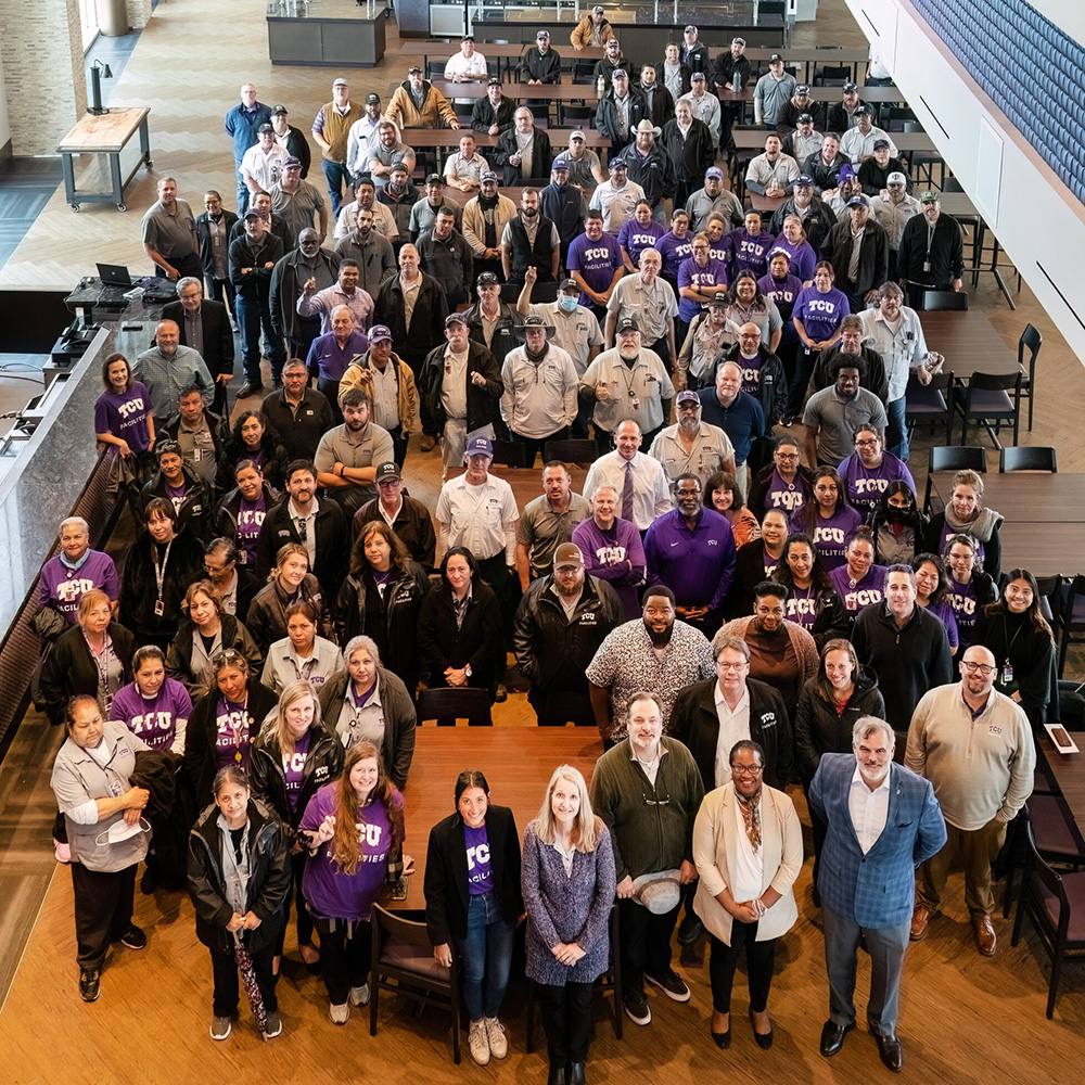 Group photo of the Facilities team, shot from a high vantage point in the Legends Club